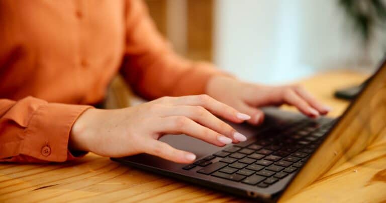 Hands, laptop or creative woman typing report, email or content writer editing article. Keyboard cl